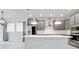 Bright kitchen features gray cabinets, stainless steel appliances, and a large quartz island at 5546 Spanish Moss Cv, Bradenton, FL 34203