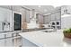 Modern kitchen featuring stainless steel appliances, gray cabinets, and quartz countertops at 5546 Spanish Moss Cv, Bradenton, FL 34203