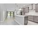 Open-concept kitchen with island, pendant lighting, and stainless steel appliances at 5546 Spanish Moss Cv, Bradenton, FL 34203