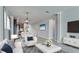 Bright and airy living room with a modern chandelier and open layout to the kitchen at 5546 Spanish Moss Cv, Bradenton, FL 34203