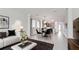 Inviting living area with neutral decor and views of the adjacent kitchen at 5546 Spanish Moss Cv, Bradenton, FL 34203