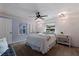 Serene bedroom features a comfortable bed, wood accent wall, and soft lighting for a relaxing atmosphere at 5690 82Nd N Ter, Pinellas Park, FL 33781