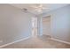 Neutral bedroom featuring an overhead ceiling fan, a closet, and a doorway to another room at 5690 82Nd N Ter, Pinellas Park, FL 33781