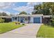 Charming single-story home with well-maintained lawn, matching blue garage and front doors at 5690 82Nd N Ter, Pinellas Park, FL 33781