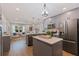 Modern kitchen with grey cabinets, stainless steel appliances, and island seating, open to the living area for easy flow at 5690 82Nd N Ter, Pinellas Park, FL 33781