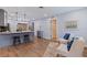 Open-concept kitchen features stylish grey cabinets, a sleek island with bar stools, and modern appliances at 5690 82Nd N Ter, Pinellas Park, FL 33781
