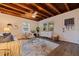 Comfortable living room with wood ceiling beams, stylish seating, and ample natural light, perfect for relaxation and gathering at 5690 82Nd N Ter, Pinellas Park, FL 33781