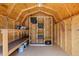 Interior of the backyard shed shows plywood walls, ceiling and storage racks and shelving at 5690 82Nd N Ter, Pinellas Park, FL 33781