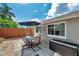 Backyard with dining set on patio, privacy fence and storage box at 5936 13Th Ave, New Port Richey, FL 34652
