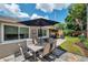 Outdoor dining set and covered patio area with views of backyard lawn at 5936 13Th Ave, New Port Richey, FL 34652