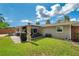 Expansive backyard featuring a cozy covered patio, outdoor dining area, lush lawn and well-maintained landscaping at 5936 13Th Ave, New Port Richey, FL 34652