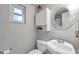 Bathroom featuring a white toilet, vanity, medicine cabinet, and a single-hung window at 5936 13Th Ave, New Port Richey, FL 34652