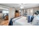 This bedroom features wood-look floors, ceiling fan, and ensuite with vanity and commode at 5936 13Th Ave, New Port Richey, FL 34652