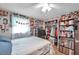 Cozy bedroom featuring ample storage, natural light, and a ceiling fan at 5936 13Th Ave, New Port Richey, FL 34652