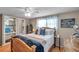 Charming bedroom featuring a wood bed frame, ceiling fan, and ensuite with vanity and commode at 5936 13Th Ave, New Port Richey, FL 34652