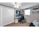 Neutral toned bedroom featuring white closet doors, a ceiling fan, and a mounted television at 5936 13Th Ave, New Port Richey, FL 34652