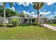 Charming single-story home featuring a well-manicured lawn, stone accents, and a welcoming front entrance at 5936 13Th Ave, New Port Richey, FL 34652