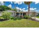 Charming single-story home featuring a well-manicured lawn, stone accents, and a welcoming front entrance at 5936 13Th Ave, New Port Richey, FL 34652