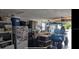 Spacious garage featuring a work bench, golf cart, cabinets, and ample storage perfect for hobbies and organization at 5936 13Th Ave, New Port Richey, FL 34652