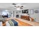 Relaxing living room with tile floors, large TV, and comfortable seating, with an adjacent office space at 5936 13Th Ave, New Port Richey, FL 34652