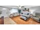Bright living room with hardwood floors, comfortable seating, and a large window that fills the space with natural light at 5936 13Th Ave, New Port Richey, FL 34652