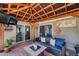 Inviting covered patio with comfortable seating, outdoor lighting, and sliding glass doors at 5936 13Th Ave, New Port Richey, FL 34652