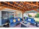 Relaxing covered patio with plush seating, outdoor decor, and open backyard view at 5936 13Th Ave, New Port Richey, FL 34652