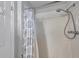 Shower featuring a white shower curtain, mounted shower head, and levered handles at 5936 13Th Ave, New Port Richey, FL 34652