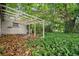 Spacious yard featuring a pergola, mature landscaping, and a small fence at 6006 Axelrod Rd, Tampa, FL 33634