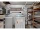 Basement with washing machine, dryer, water heater, and storage shelves at 6006 Axelrod Rd, Tampa, FL 33634