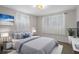 Bedroom staged with large bed and overhead lighting at 6006 Axelrod Rd, Tampa, FL 33634