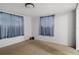 A bedroom with two windows and a ceiling light at 6006 Axelrod Rd, Tampa, FL 33634