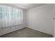 Bright bedroom with large window and neutral carpeting at 6006 Axelrod Rd, Tampa, FL 33634