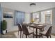 Dining room staged with table, chairs, painting, and plant near the window at 6006 Axelrod Rd, Tampa, FL 33634