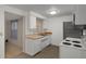 A kitchen with white cabinets and a view to another room at 6006 Axelrod Rd, Tampa, FL 33634