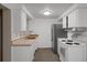 A kitchen with white cabinets, a stainless steel refrigerator and an oven at 6006 Axelrod Rd, Tampa, FL 33634