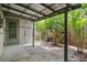 Covered patio with open beams, concrete pavers, and view of the lush backyard at 6006 Axelrod Rd, Tampa, FL 33634