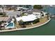 Waterfront home featuring lush landscaping, a private pool, and beautiful curb appeal at 649 Normandy Rd, Madeira Beach, FL 33708