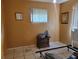 Empty bedroom featuring tan walls, tiled floor, bright window and space for furniture at 6818 59Th St, N., Pinellas Park, FL 33781