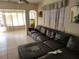 Cozy living room featuring tile flooring, a large leather sectional sofa, and bright natural light at 6818 59Th St, N., Pinellas Park, FL 33781