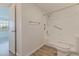 Bathroom featuring handicap bar, walk-in shower, white commode, and wood flooring, plus a door to bedroom at 6826 Stones Throw N Cir # 11308, St Petersburg, FL 33710