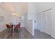 Bright dining area featuring a modern chandelier, wood floors and natural light through a window with white blinds at 6826 Stones Throw N Cir # 11308, St Petersburg, FL 33710