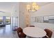 Dining area with modern chandelier and decor, flowing to kitchen and living areas at 6826 Stones Throw N Cir # 11308, St Petersburg, FL 33710