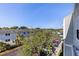 Exterior shot of the building shows parking and mature landscaping at 6826 Stones Throw N Cir # 11308, St Petersburg, FL 33710