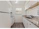 Bright kitchen featuring modern white cabinets, stainless appliances, granite countertops, and wood flooring at 6826 Stones Throw N Cir # 11308, St Petersburg, FL 33710