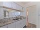This open kitchen showcases stainless steel appliances, granite countertops and white cabinets that enhance natural light at 6826 Stones Throw N Cir # 11308, St Petersburg, FL 33710