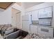 Bright kitchen featuring white appliances, white cabinets with granite countertops, wood flooring, and stainless steel sink at 6826 Stones Throw N Cir # 11308, St Petersburg, FL 33710