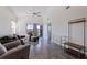Bright living room featuring vaulted ceiling, ceiling fan, balcony access, and stylish wood grain floors at 6826 Stones Throw N Cir # 11308, St Petersburg, FL 33710