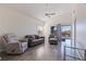 Comfortable living room featuring natural light, vaulted ceiling, and access to the balcony at 6826 Stones Throw N Cir # 11308, St Petersburg, FL 33710