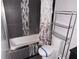 Modern bathroom with gray tile, decorative mosaic accents, and a shower-tub combination at 7031 Drury St, Tampa, FL 33635